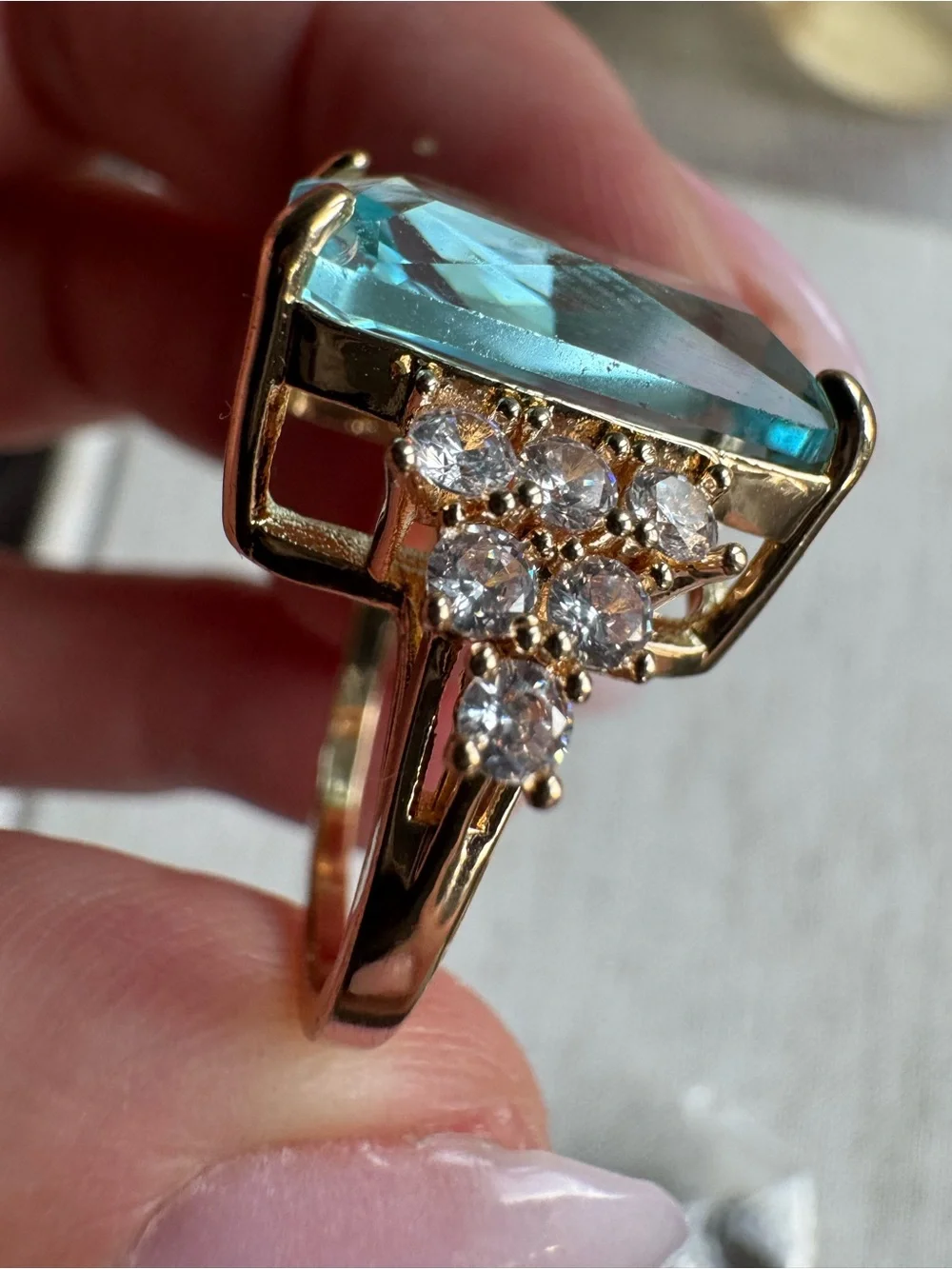 Stunning gold tone ring with blue crystal